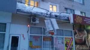 В Брянске упавшая с крыши глыба льда разбила козырек магазина